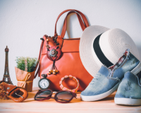 womens accessories on wooden floor white hat orange handbag light brown glasses denum shoes brown belt pink bangle african inspired necklace from photobyphotoboy via Canva