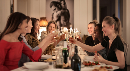 women at dinner party Andrea Piaquadio Pexels via Canva